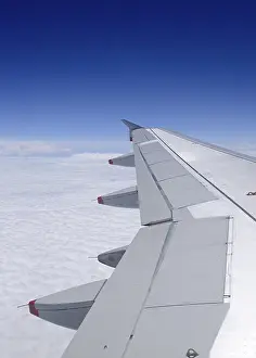 Deserted Airplane Scene Drucke: Airplane wing in flight over white clouds