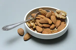 Nutritionally Rich Foods Drucke: Almonds and walnuts in shell with spoon