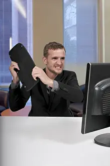 Single Person Working Hard Drucke: Angry man using a desktop computer for business