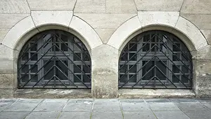 Stone Wall Architecture Drucke: Two arched windows in a stone wall with symmetrical lattice elements