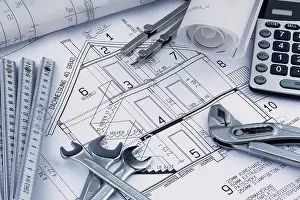 Architect Construction Plan Drucke: An architect's construction plan with a calculator