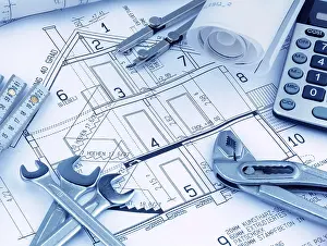 Architect Construction Plan Drucke: An architect's construction plan with a calculator