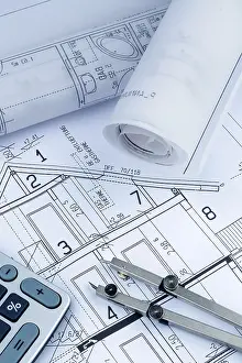 Architect Construction Plan Drucke: An architect's construction plan with a calculator
