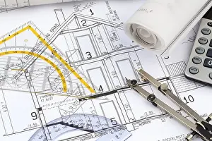 Architect Construction Plan Drucke: An architect's construction plan with a calculator