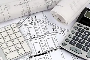 Architect Construction Plan Drucke: An architect's construction plan with a calculator