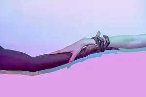 Peaceful Teamwork Image Drucke: Artistic composition of multiethnic hands touching against a vibrant gradient background
