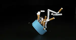 Dark Background Studio Shot Drucke: Ashtray and Cigarettes Falling against Black Background