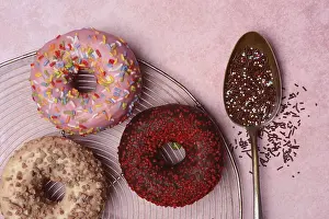 Assorted Donuts Drucke: Assorted donuts with icing and spoon with sugar sprinkles