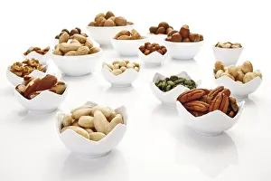 Assorted Nuts Drucke: Assorted nuts and kernels in ceramic bowls
