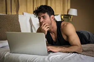 Young Man Working Drucke: Attractive Young Man with Serious Expression