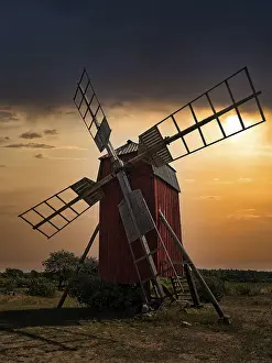 Scandinavian Tourist Attraction Drucke: Backlit trestle windmill, dramatic evening sky