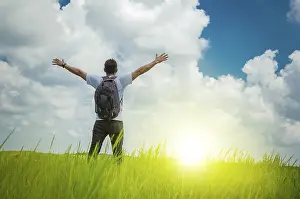 Copy Space For Text Idea Drucke: A backpacker on a hill with blue sky and copy space