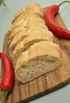 Healthy Eating Habits Image Drucke: Baguette bread with two chilies on a kitchen table