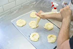 Rustic Bakery Interior Drucke: Baker of bakery in the workshop workshop of artisan bakery preparing the buns before baking