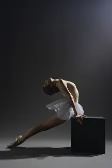 Dark Studio Photography Drucke: A ballet dancer performs a graceful pose