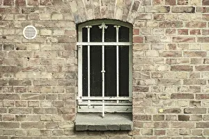 Historic Building Facade Drucke: Barred cellar window in a brick wall