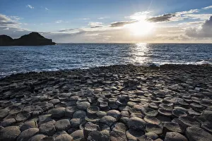 Deserted Coastline At Dusk Drucke: Basalt columns by the coast at sunset