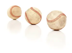 Isolated On A White Background Drucke: Three baseballs isolated on a reflective white background