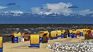 Dramatic Sky Photography Drucke: Several beach chairs along a windy beach with dramatic sky in the background
