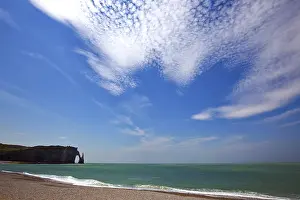 Overcast Sky And Sea Drucke: Beach with rocks under cloudy sky