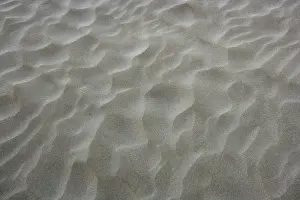 Uninhabited Shoreline View Drucke: Beach sand waves warm texture pattern background