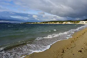 European Shoreline Photography Drucke: Beach with waves and a cloudy sky up to the horizon