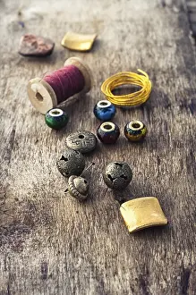 Wooden Craft Background Drucke: Beads, thread, wire and tools for needlework on the old wooden background