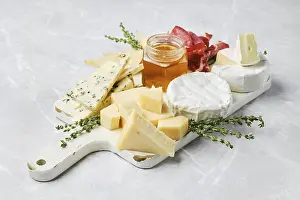 Wooden Board Arrangement Drucke: A beautiful spread featuring various types of cheese