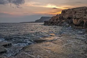 Atmospheric Evening Light Scene Drucke: Beautiful sunset over cliffs and ocean