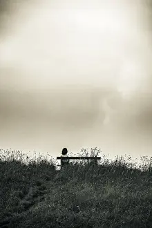 Dramatic Clouds Drucke: Bench and mountaineer and dramatic clouds in the background