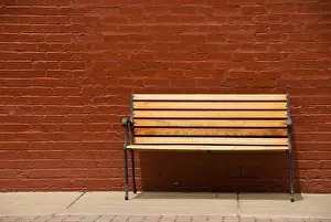 Brick Exterior Design Drucke: A bench beside a red brick wall