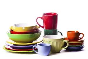 White Background Tableware Drucke: Big stack of different colors mugs and plate on white background