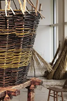 Wicker Basket Drucke: Big Wickerwork basket with vegetable material at background
