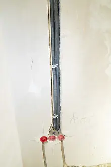 Electrical Installation Drucke: Black cable ducts inserted into the wall