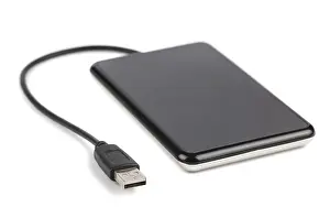 Bright Studio Photography Setup Drucke: Black external hard disk with cable isolated on white background