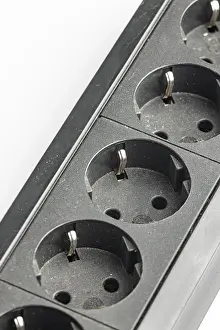 Power Industry Equipment Drucke: Part of a black plastic socket strip with empty sockets