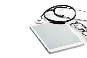 Medical Care Concept Drucke: Black stethoscope and tablet over white background space for text