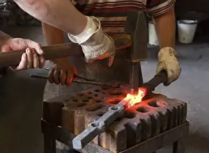 Protective Clothing Workwear Drucke: Blacksmith and his assistant at work