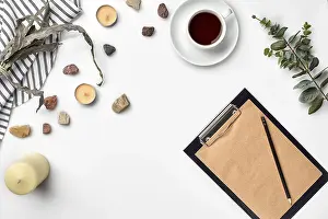 Education Background Drucke: Blank opened notebook with cup of coffee on white table