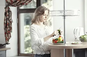 Easy Breakfast Ideas Drucke: Blond lady at kitchen preparing vegetable for breakfast