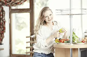 Vegetable Starter Dishes Drucke: Blond lady at kitchen preparing vegetable for breakfast
