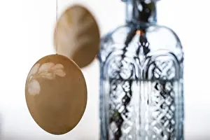Colourful Easter Decorations Drucke: Blown out Easter eggs, a light blue vase in the background