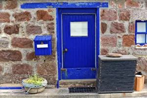 Rocky Coastline Europe Drucke: Blue door in a rustic brick wall with a small window and mailbox