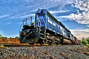 Sunrise Rail Traffic Drucke: Blue freight train engine at sunrise