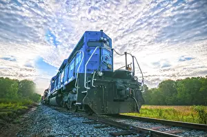 Sunrise Rail Traffic Drucke: Blue freight train engine at sunrise