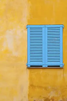 Deserted House Window Drucke: Blue shutter on yellow plaster wall