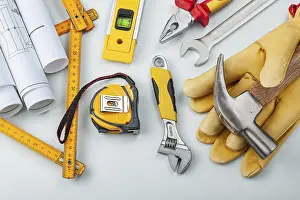 Professional Working Clothes Drucke: Blueprints Gloves And Construction Tools On White Background