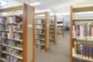 Public Institution Backdrop Drucke: Blurry interior library aisle background