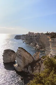 Deserted Cityscape At Sunset Drucke: Bonifacio with its limestone cliffs in the foreground