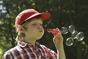 Casual Clothing Portrait Drucke: Boy blowing soap bubbles